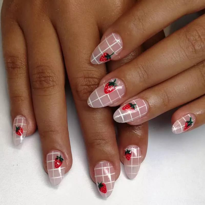 White graph nail design with strawberry accents