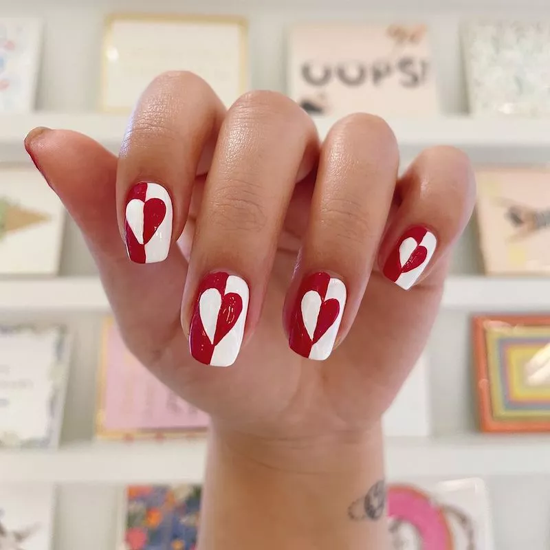 Red and white split heart nail design