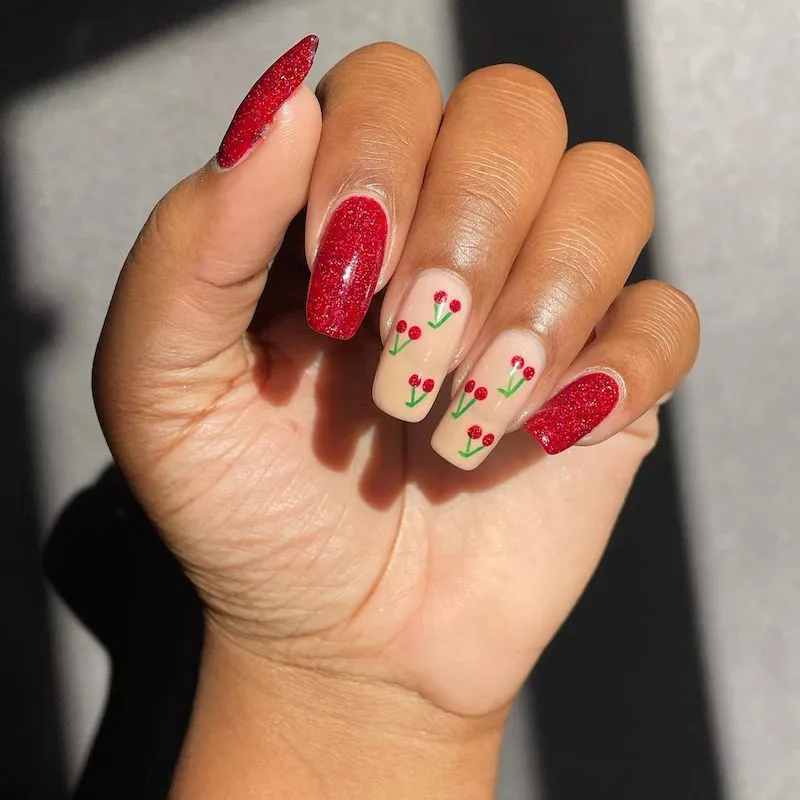 Red glitter manicure with cherry nude accent nails