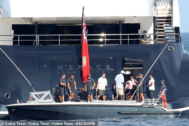 The Jordan family clamber off the speedboat on to the luxury yacht off the coast of Sicily