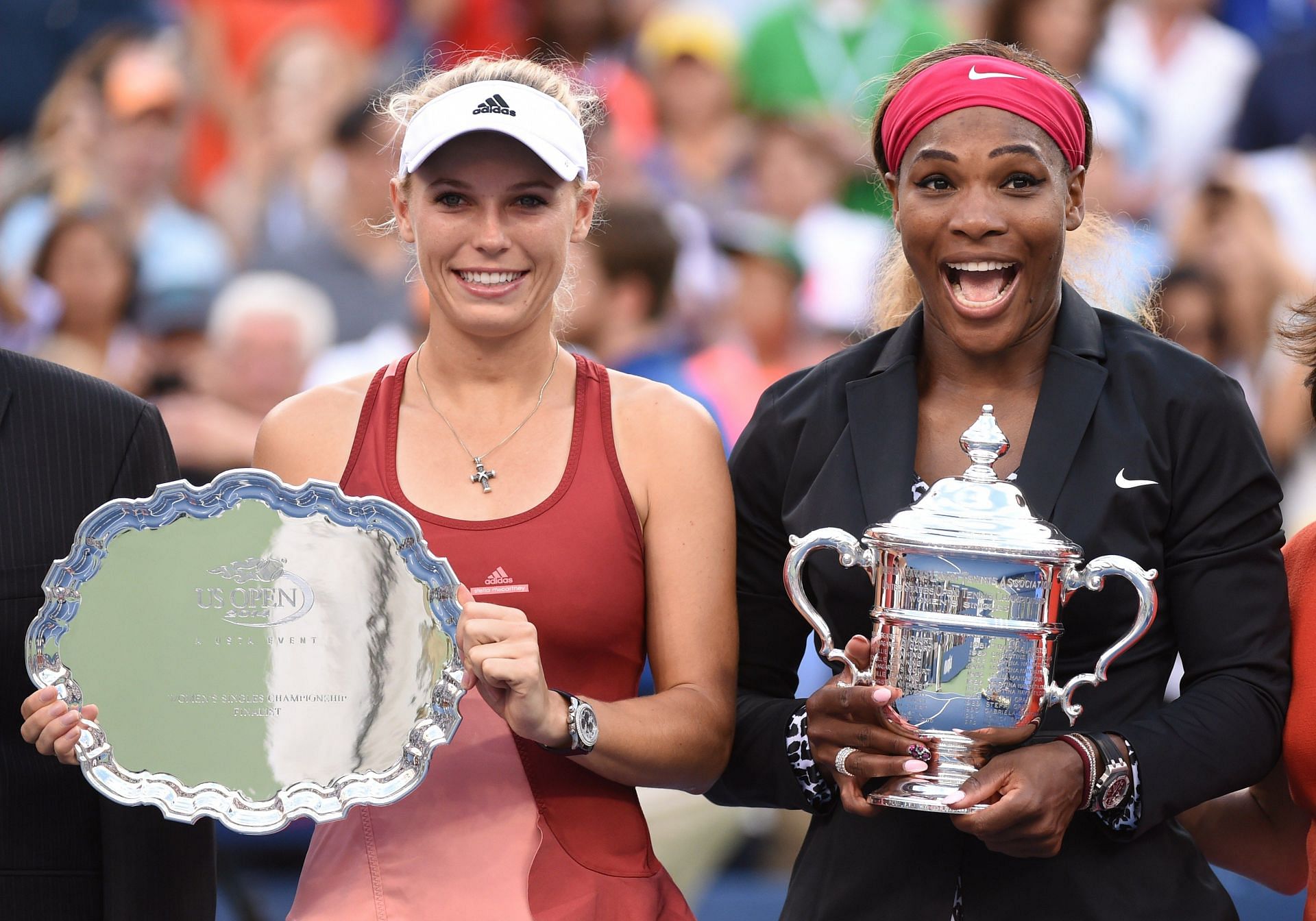 Serena Williams and Caroline Wozniacki pose at the 2014 US Open trophy ceremony