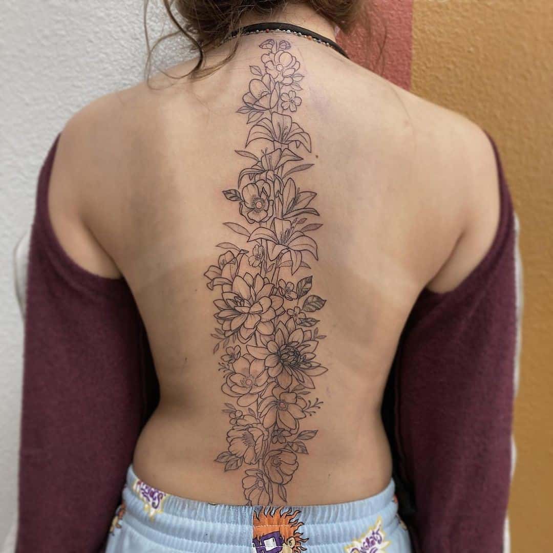 Dramatic Long Bold Flower Spine Tattoo