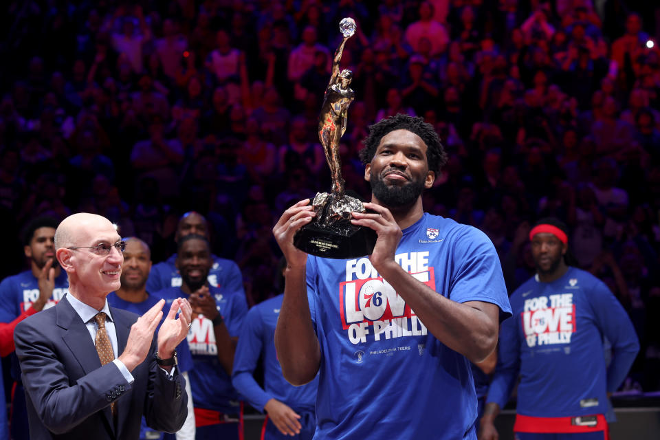 Philadelphia 76ers center Joel Embiid hoists the 2022-23 MVP trophy prior to Game 3 of the Eastern Conference second round against the Boston Celtics at Wells Fargo Center in Philadelphia, on May 5, 2023. (Photo by Tim Nwachukwu/Getty Images)