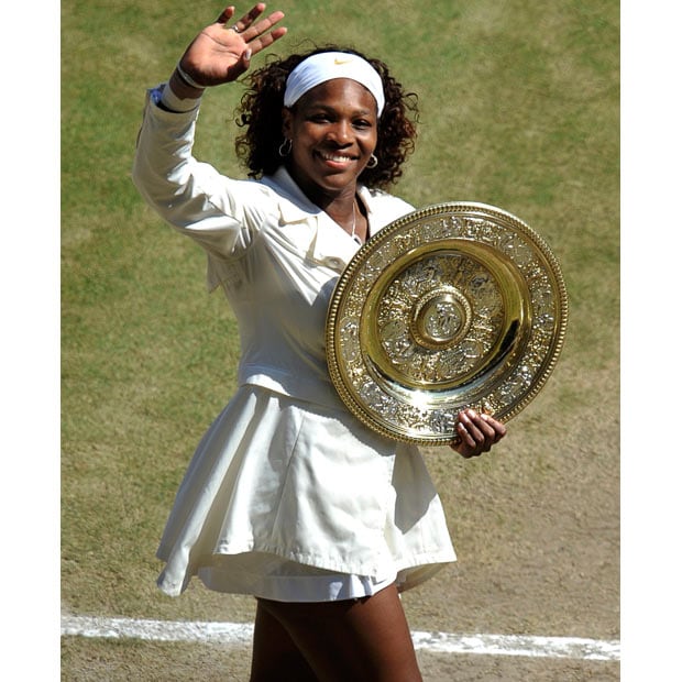 Serena Williams of the U.S. holds her trophy after defeating Venus Williams of the U.S. in their Ladies' Singles finals match at the Wimbledon tennis championships in London