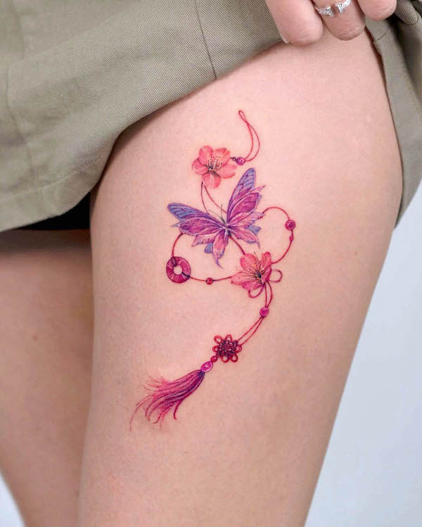 Butterfly and norigae thigh tattoo by @tilda_tattoo