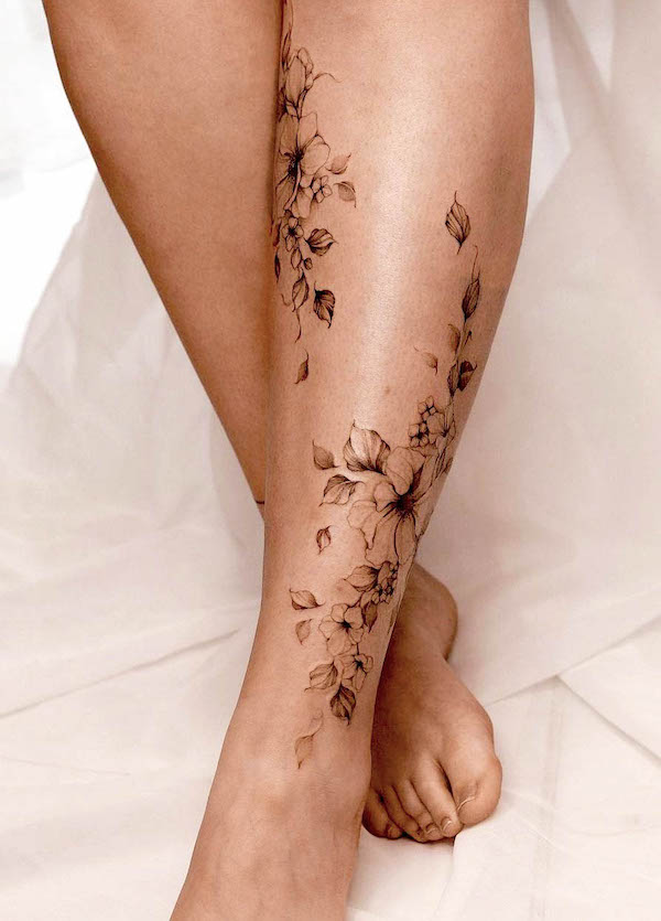 Dainty flowers calf tattoo by @nia.tattooing