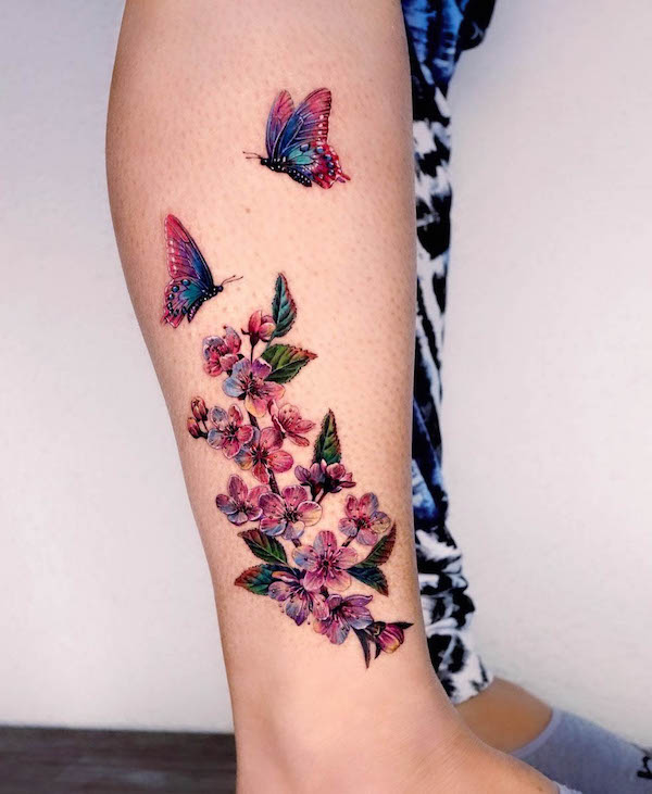 Flowers and butterfly leg tattoo for women by @non_lee_ink