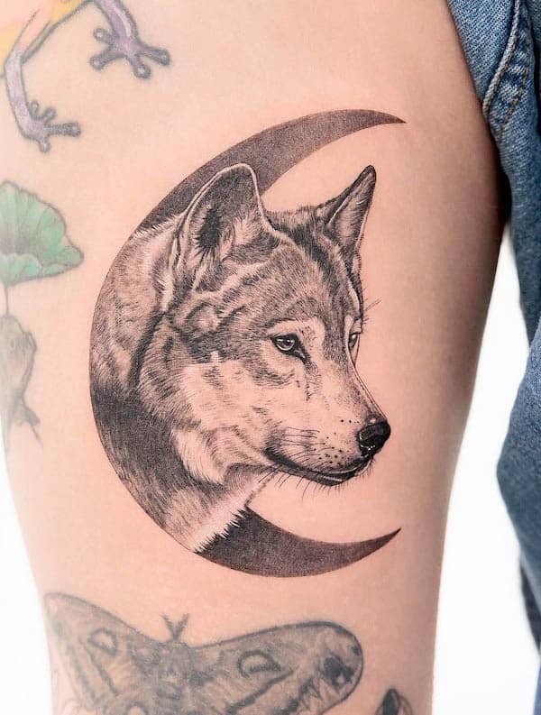 Moon and wolf leg tattoo for women by @lozzarachtattooer