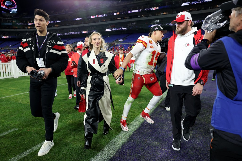 patrick and brittany mahomes walking on the football field