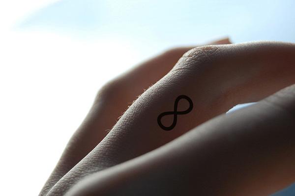 Infinity symbol tattoo on finger