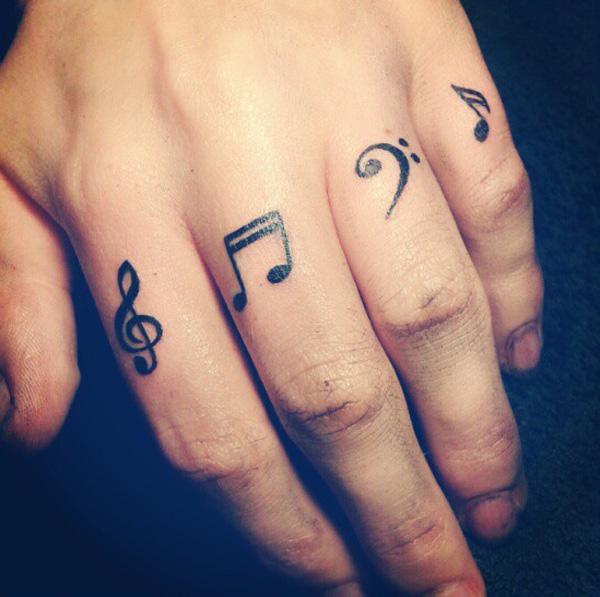 Music note finger tattoo