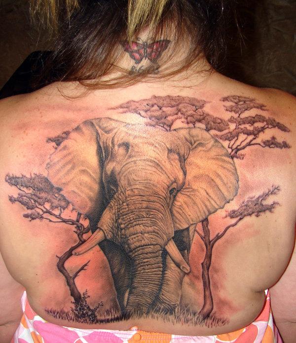 Realistic elephant and trees back tattoo
