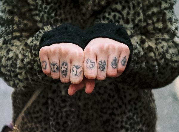 Dotwork symbols on the fingers of two hands