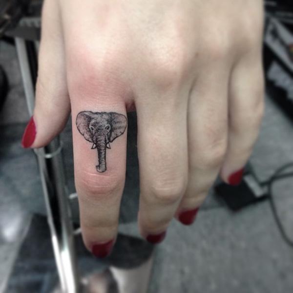 Black and grey elephant head finger tattoo