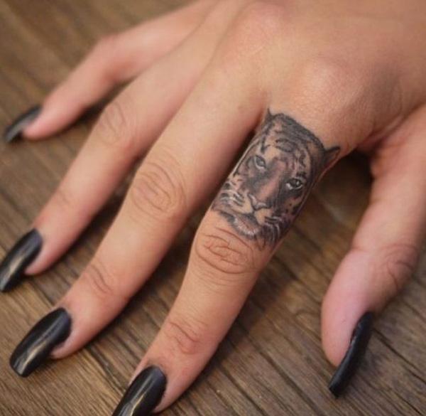 Tiger finger tattoo