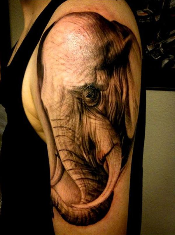 A realistic elephant head shoulder tattoo