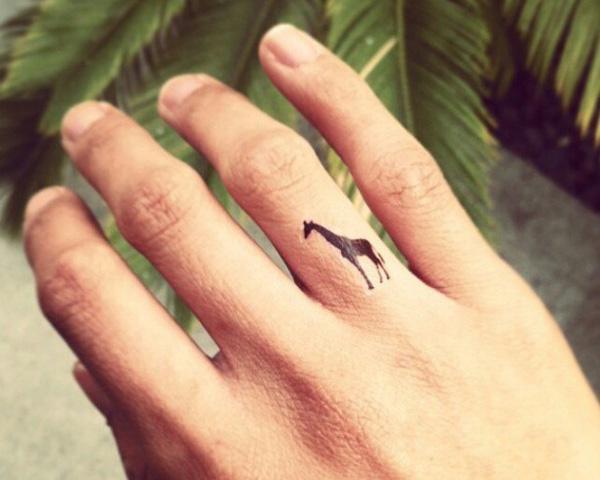 Giraffe tattoo on ring finger