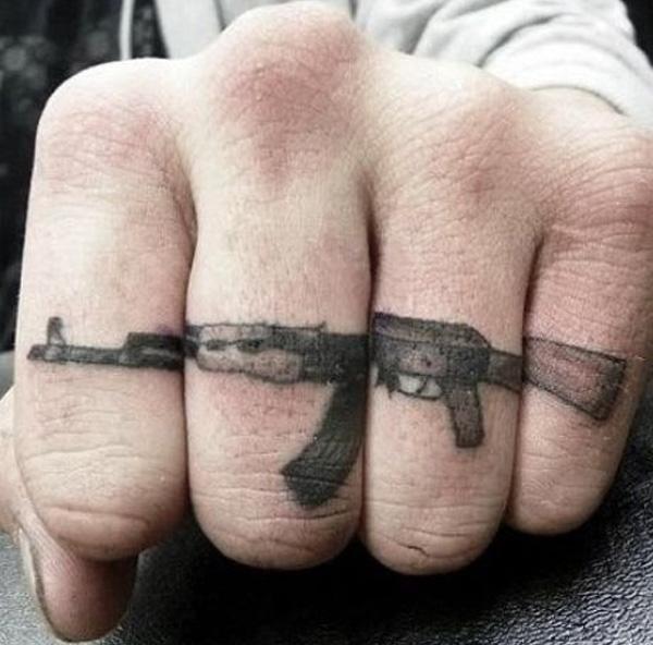 AK 47 Rifle finger tattoo