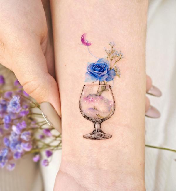 A blue rose in wine glass