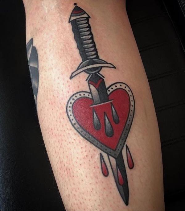A dagger though a heart tattoo