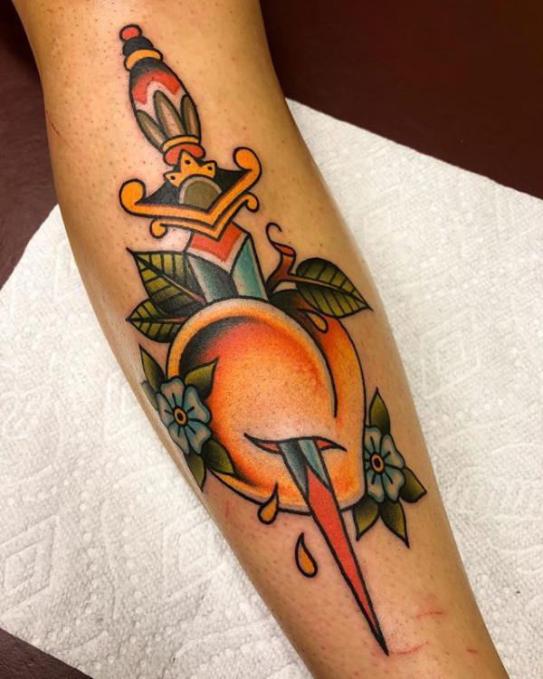 A dagger throug a peach tattoo traditional