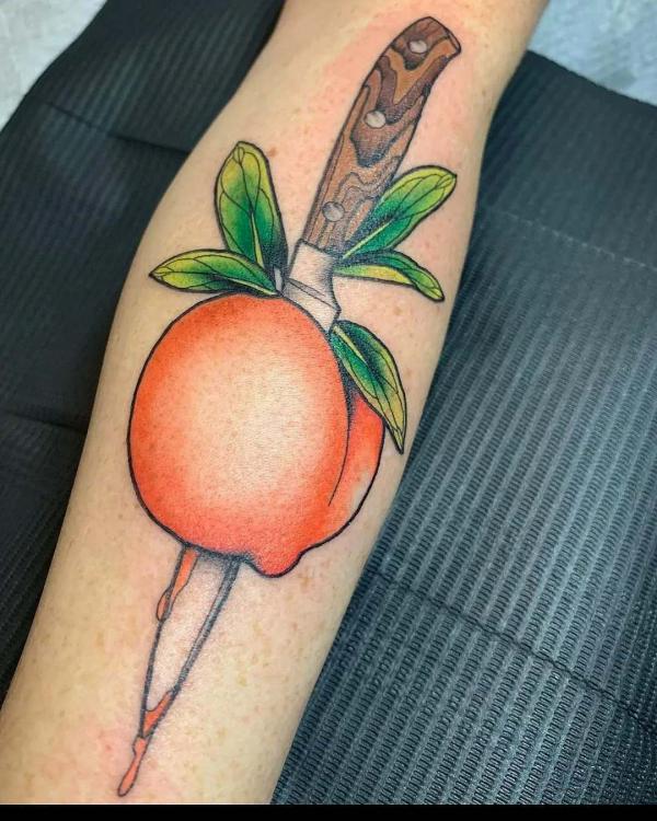 A knife through peach tattoo