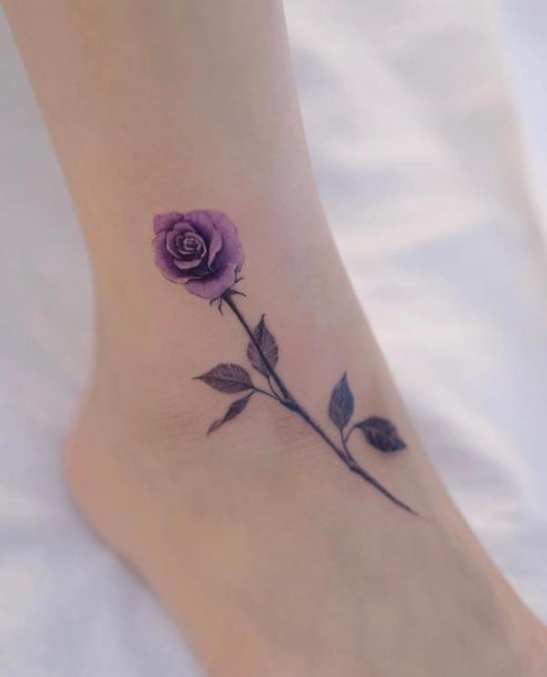 A stem of purple rose tattoo on ankle