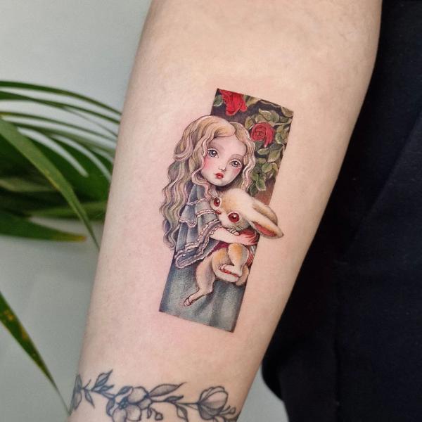 Alice holding a rabbit rectangular tattoo