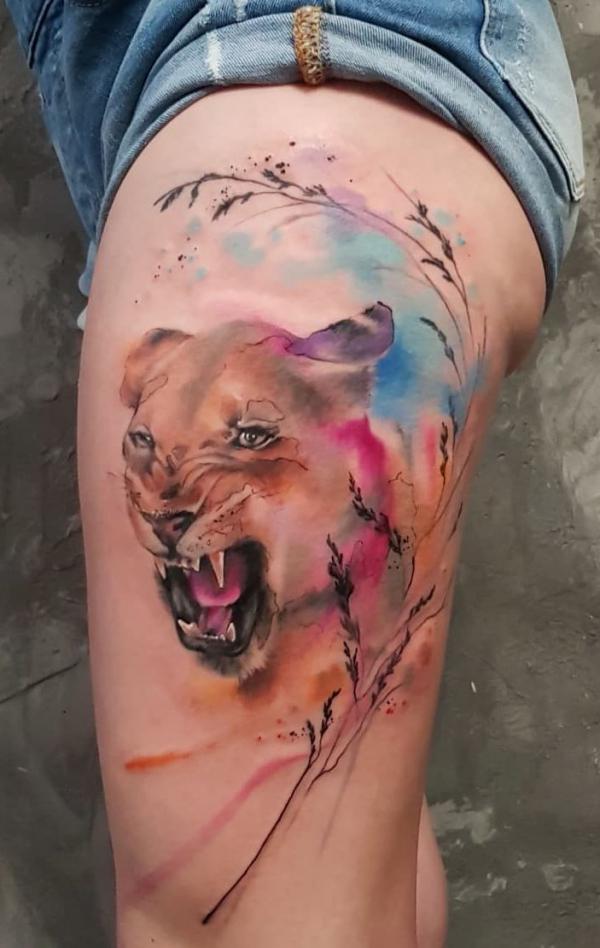 Angry lioness thigh tattoo watercolor