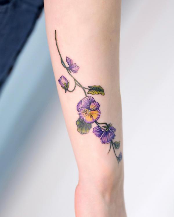 Beautiful violet flowers on the forearm