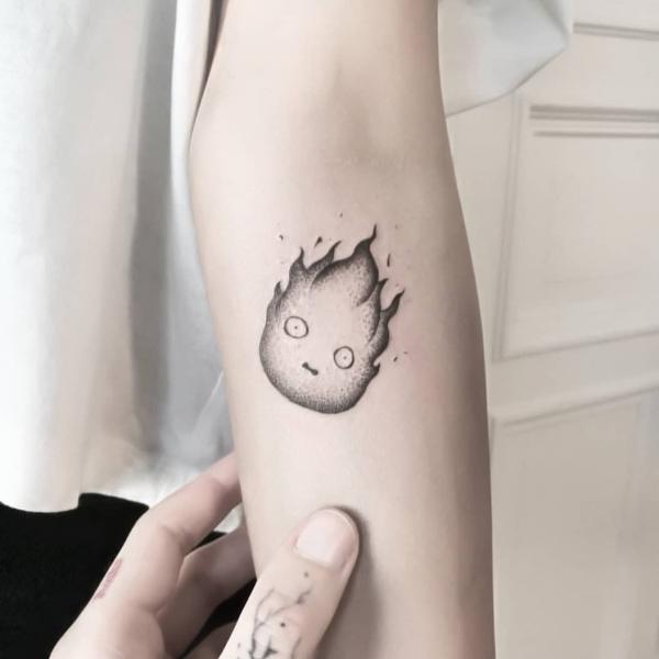 Black and grey Calcifer elbow tattoo