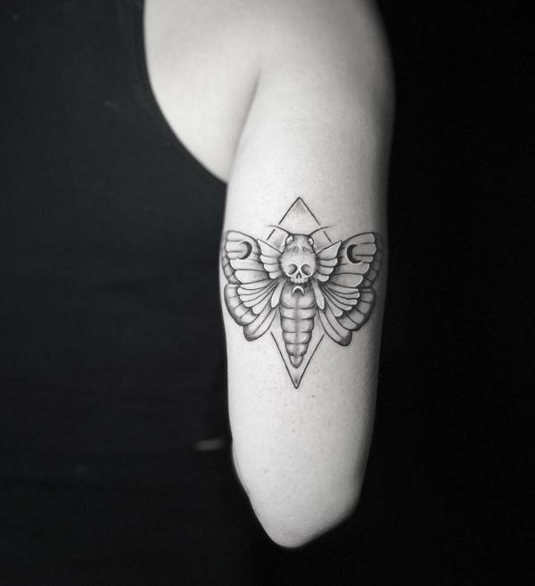 Black and grey death moth tattoo on upper arm