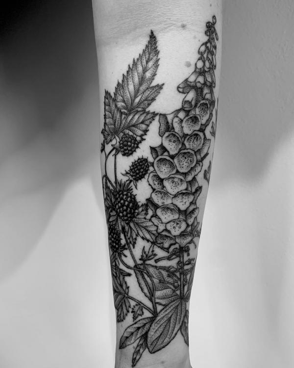 Black and grey foxglove and strawberry tattoo