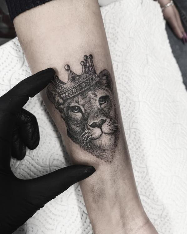 Black and grey lioness queen forearm tattoo