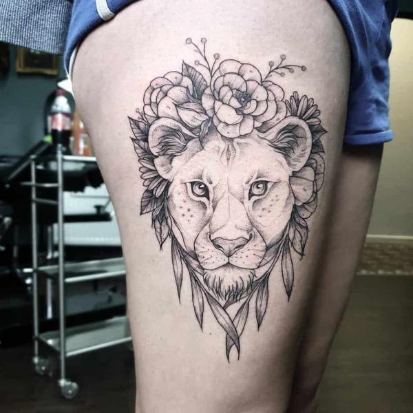 Black and grey lioness with flowers tattoo thigh