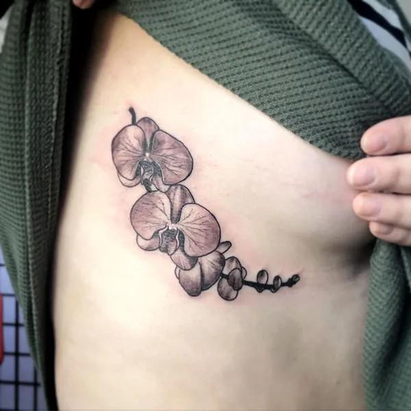 Black and grey orchid side boob tattoo