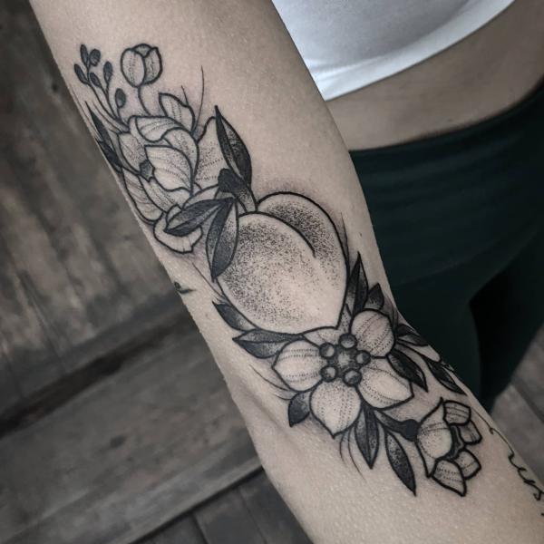 Black and grey peach with flowers arm tattoo