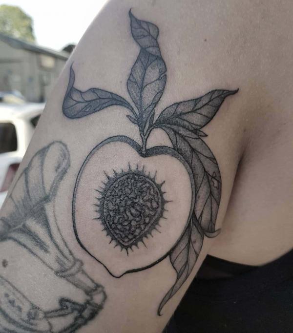 Black and grey sliced peach tattoo