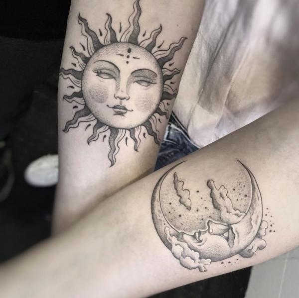 Black and grey sun and moon faces tattoo