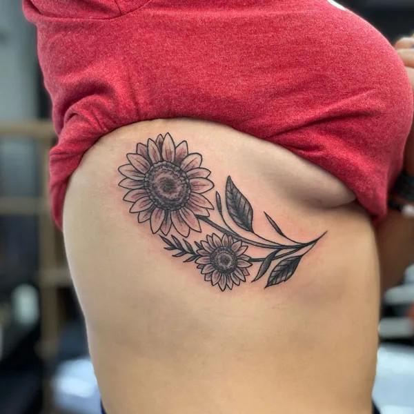 Black and grey sunflower side boob tattoo