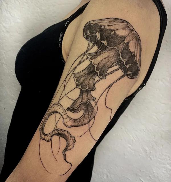 Black and white jellyfish upper arm tattoo