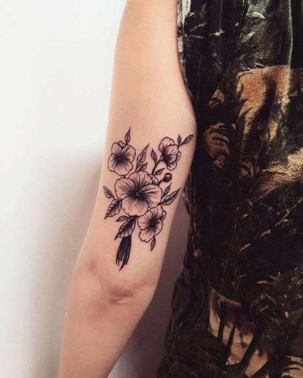 Black and white violet flowers on the back of upperarm