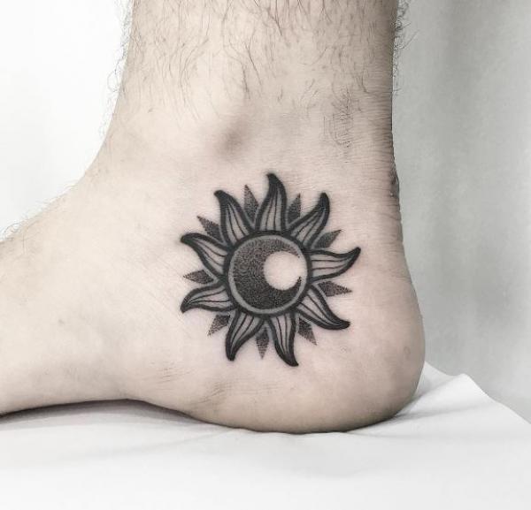 Blackwork sun and moon ankle tattoo