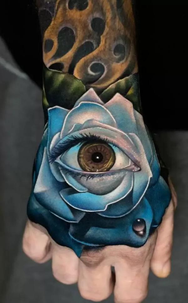 Blue Rose with eye tattoo on hand