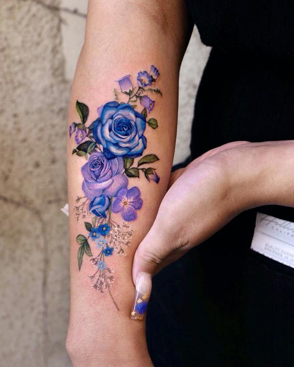 Blue and purple roses forearm tattoo