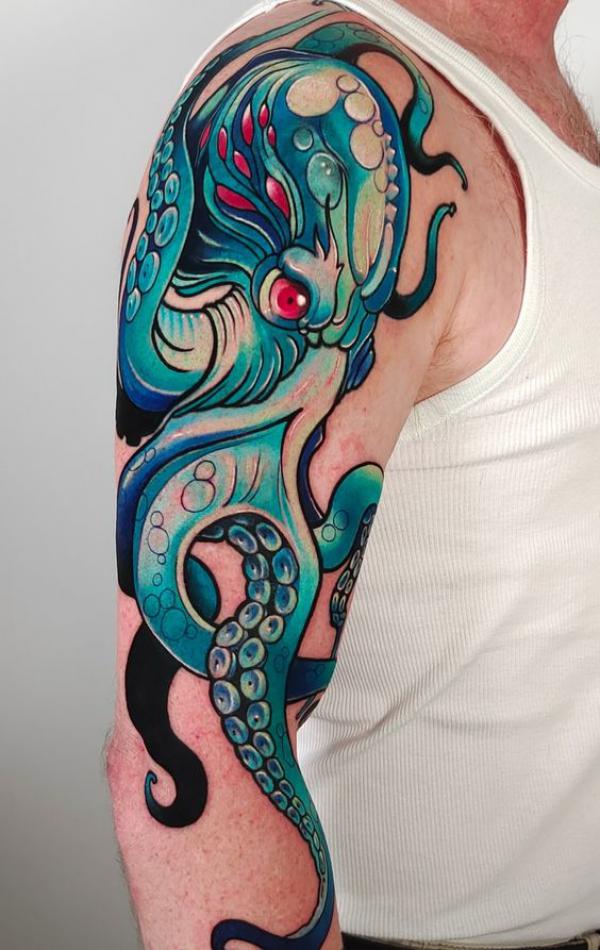 Blue octopus upper arm tattoo