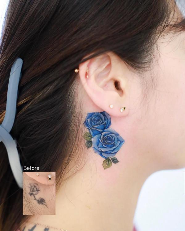 Blue rose cover up tattoo behind ear