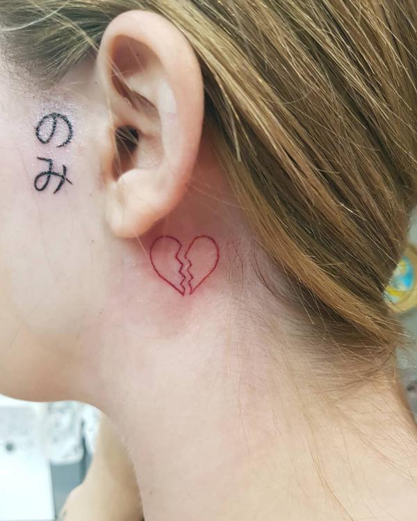 Broken heart outline tattoo behind the ear