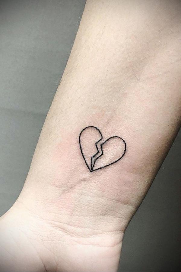 Broken heart outline wrist tattoo