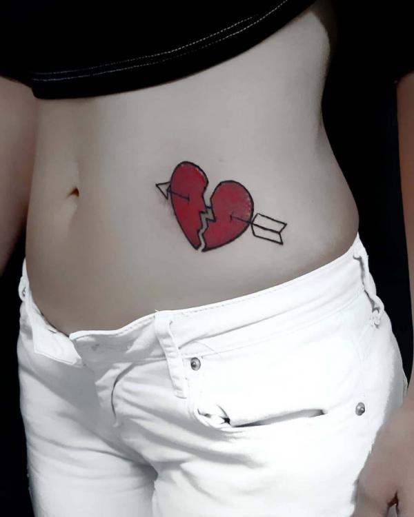 Broken heart with arrow through it tattoo on side